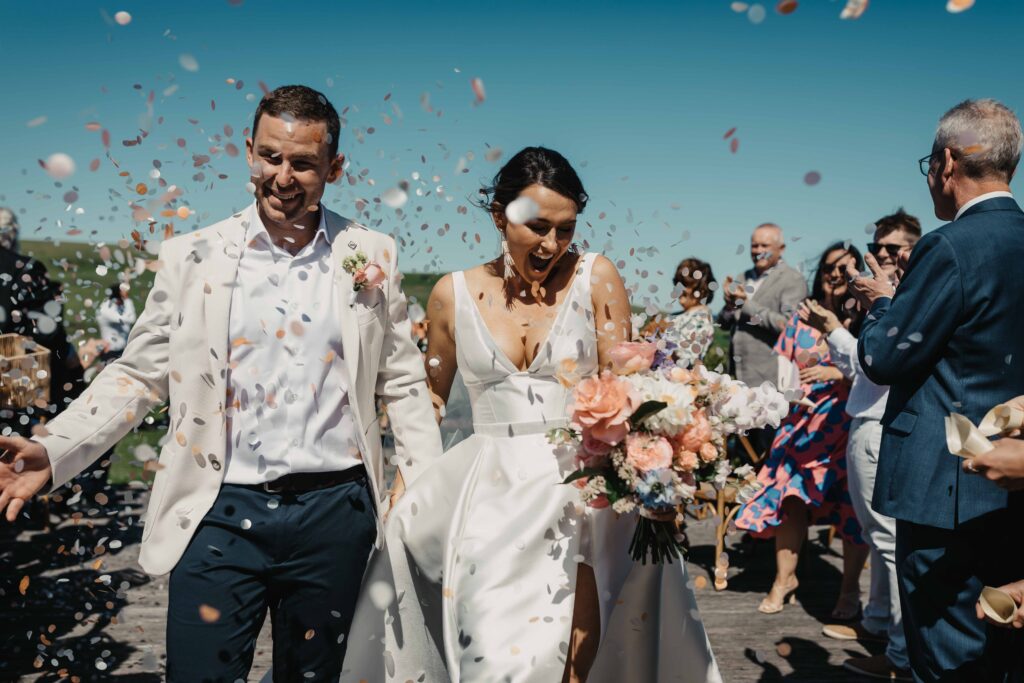 confetti throw photo with husband and wife at Seacliff house, nsw