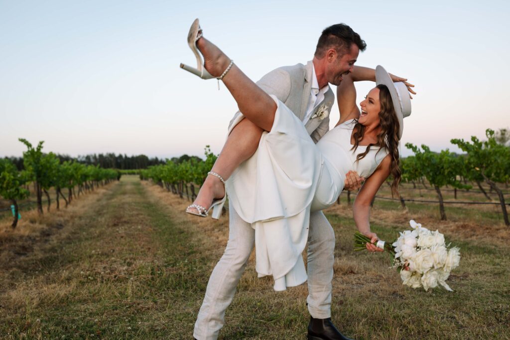 husband picking up his wife at Peterson House in the hunter valley amongst the vines