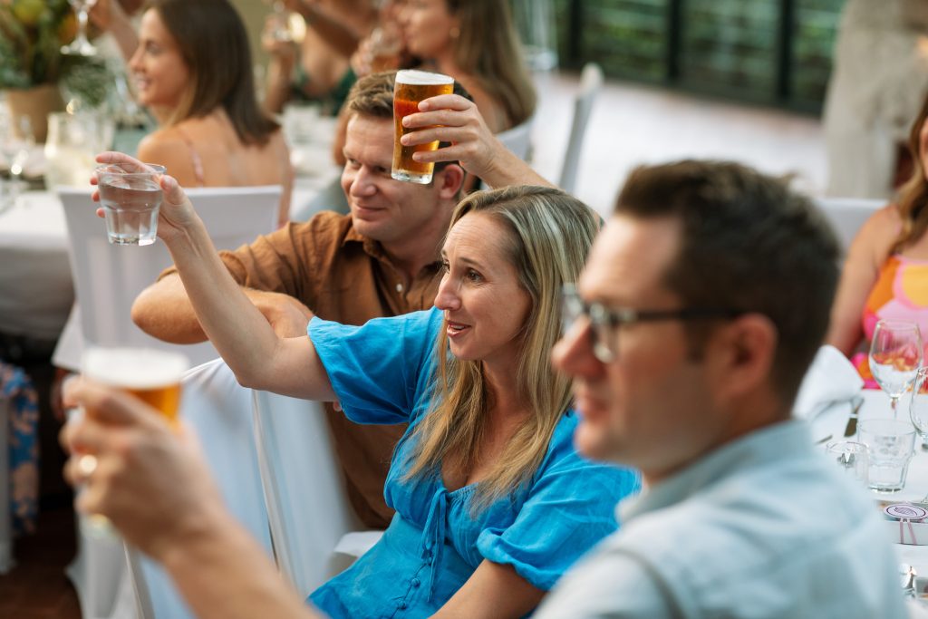 guests cheering at speeches at raffertys resort during the wedding reception