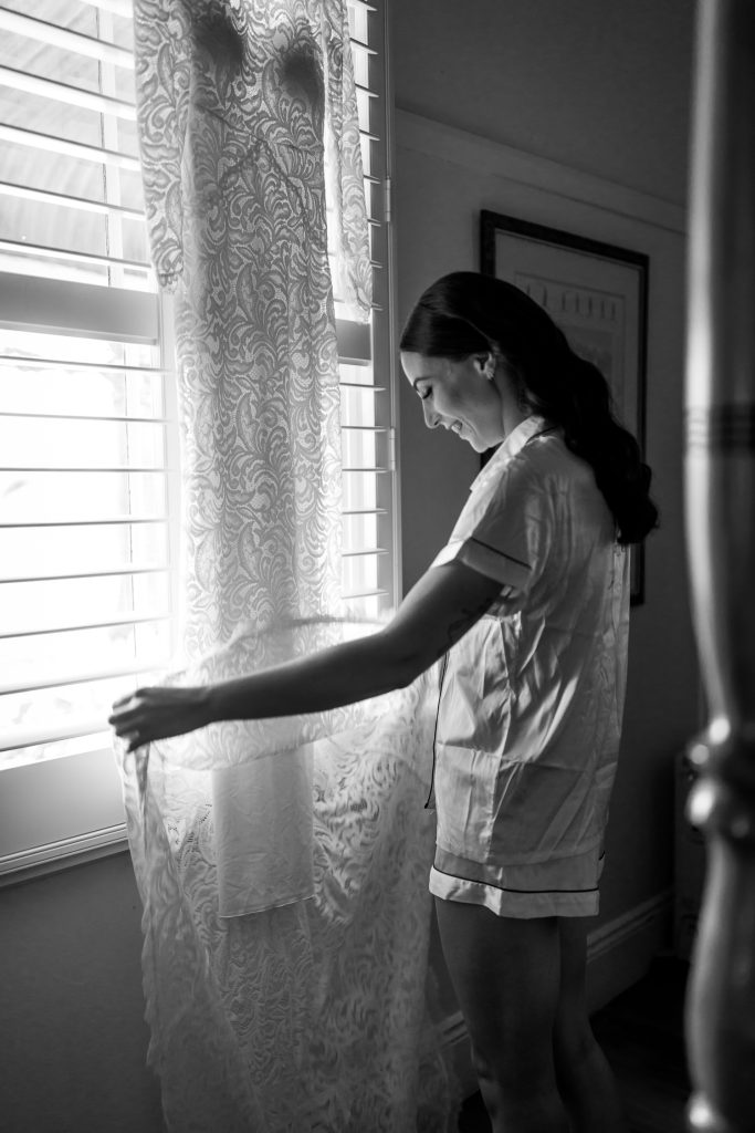 Bride admiring her dress during prep at her wedding in the hunter valley
