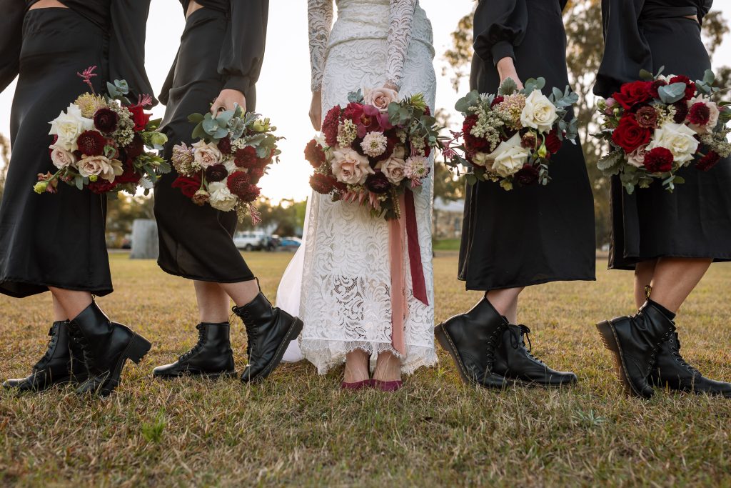 bride with her bridesmaids and flowers on location photos at their wedding in the hunter valley