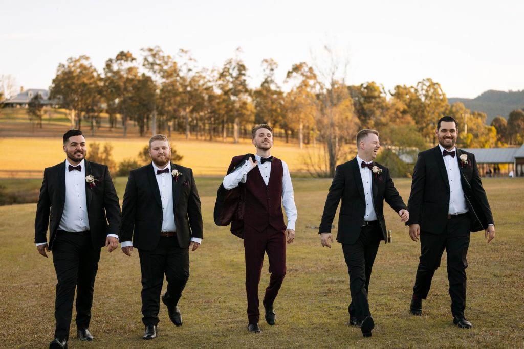 groom and groomsmen walking on location photos at their wedding in the hunter valley