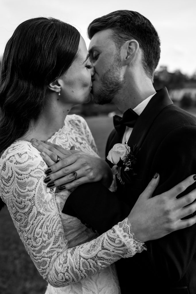 bride and groom close kissing location photos in black and white at their wedding in the hunter valley