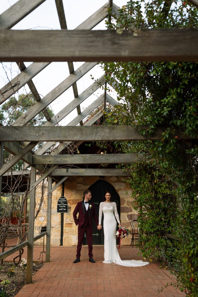 bride and groom location photos standing in front of chapel at their wedding in the hunter valley