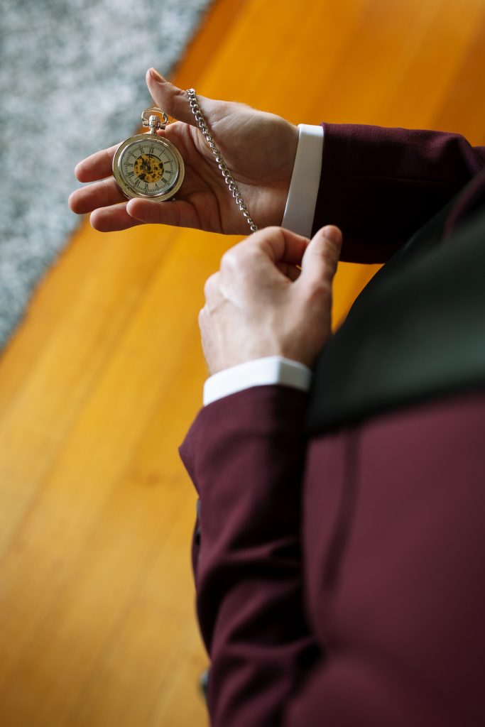 Groom with his pocket watch and accessories during prep at his wedding in the hunter valley