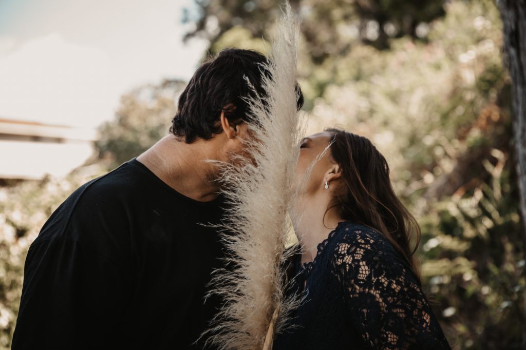 kissing in the park engagement shoot