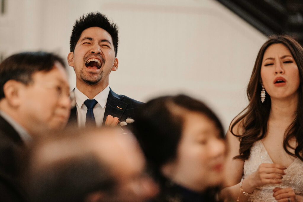 groom laughing at reception