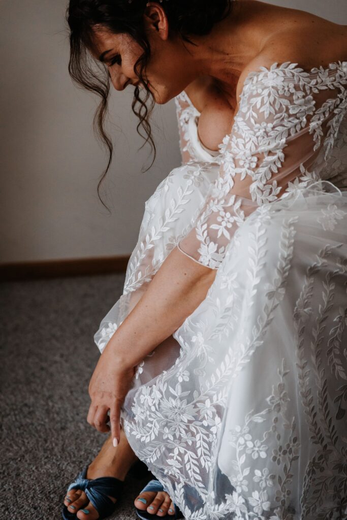 bride putting on shoes broke wedding