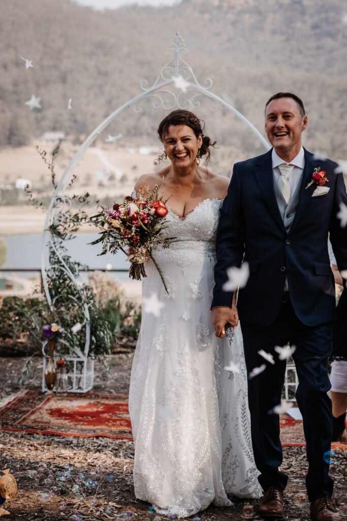bride and groom being showered with confetti