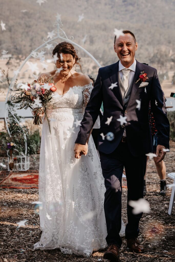 bride and groom being showered with confetti