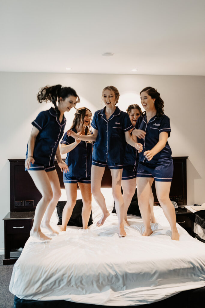 Bridesmaids jumping on the bed