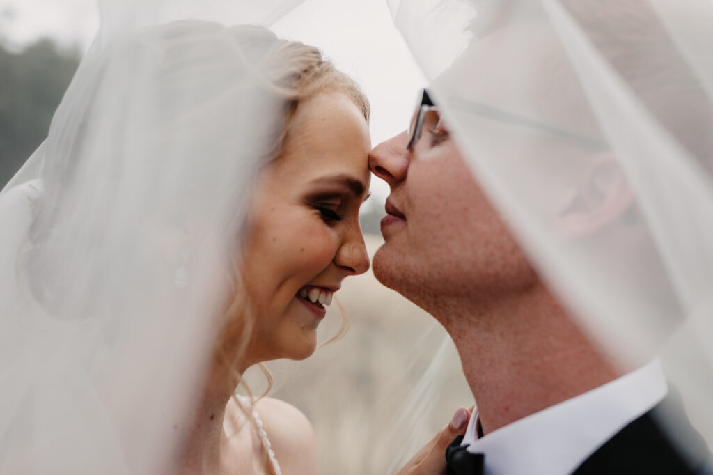 Husband and wife under the veil on a location shoot Wagga Wagga