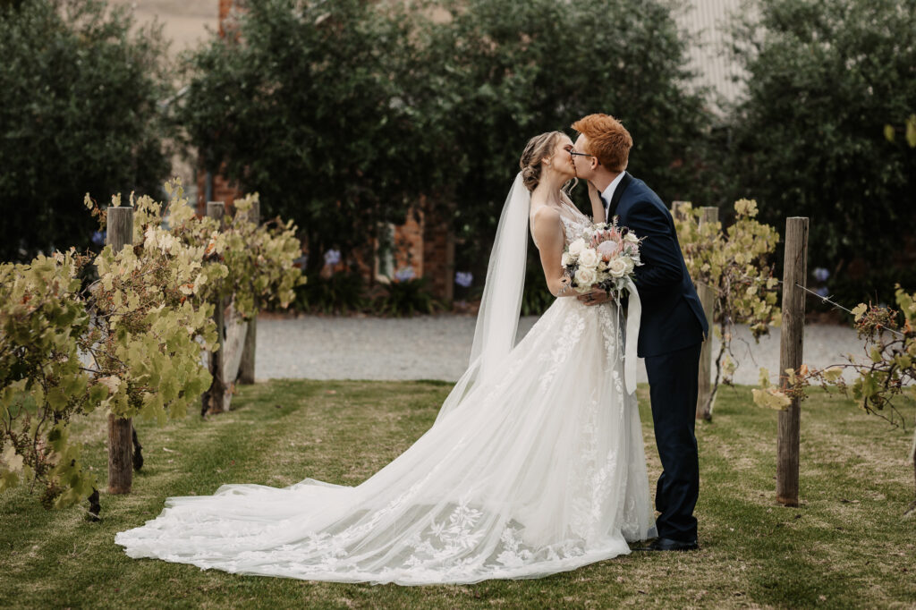 Husband and wife kissing on a location shoot Wagga Wagga