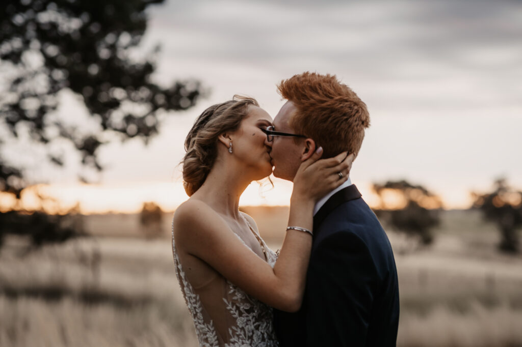 Husband and wife kissing at sunset on a location shoot Wagga Wagga
