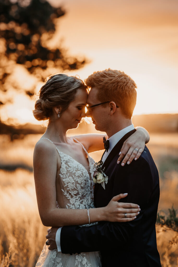 Husband and wife kissing at sunset on a location shoot Wagga Wagga
