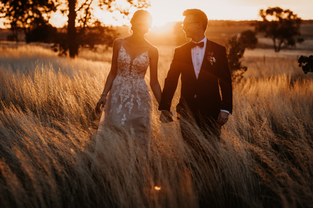 Husband and wife walking at sunset on a location shoot Wagga Wagga