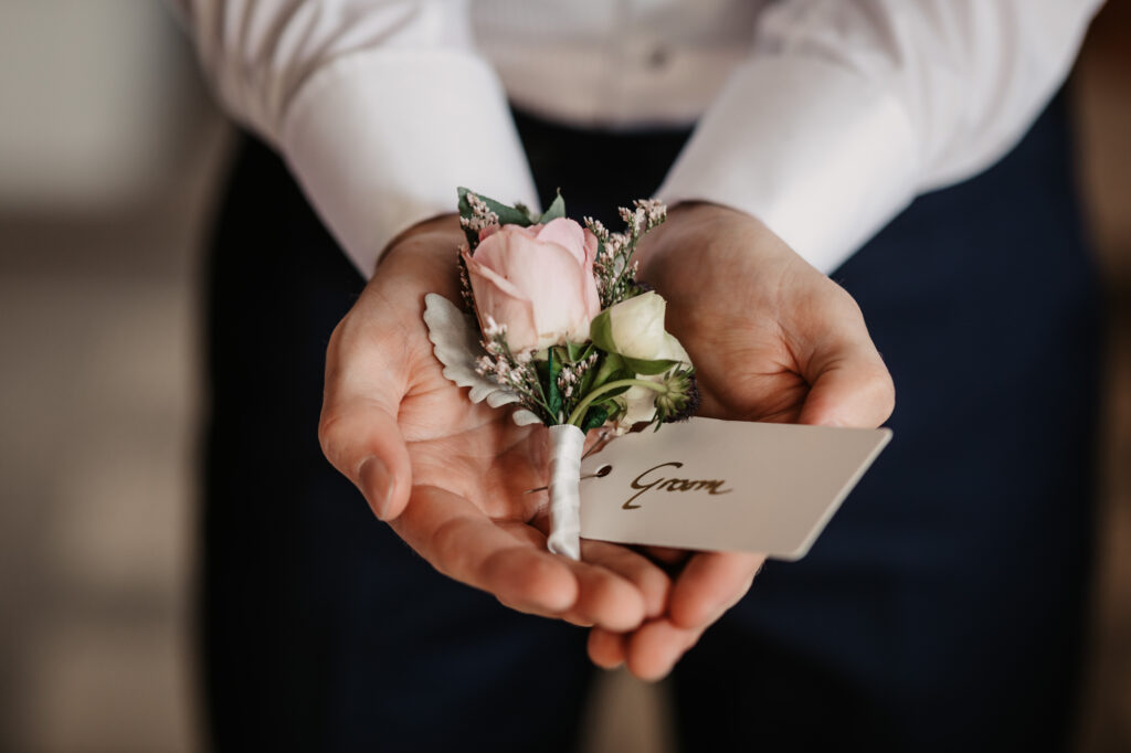 Groom button hole getting ready