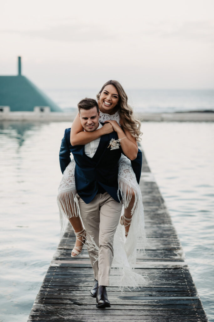 bride and groom piggy back