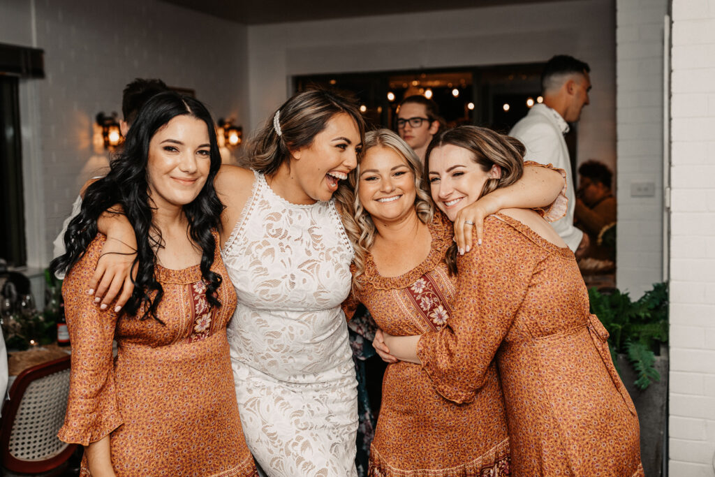 bride and bridesmaids group hug
