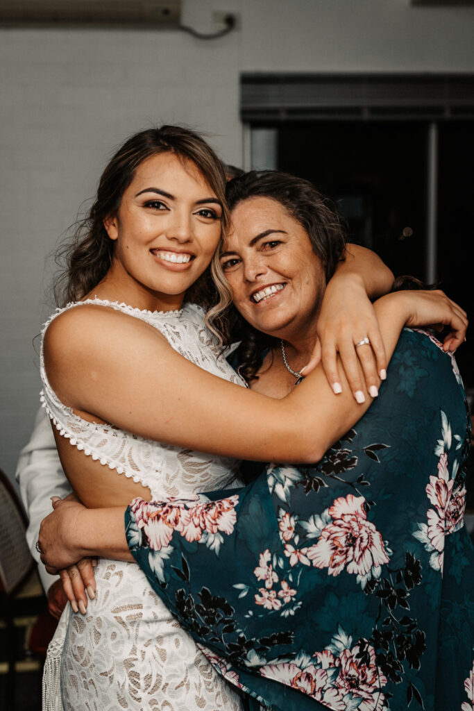 Bride and mother hug