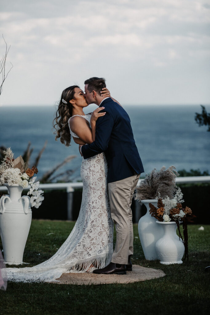 bride and groom first kiss Newcastle beach