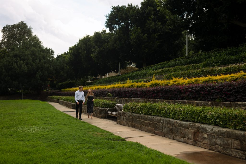 couple walking holding hands in Newcastle on their engagement session