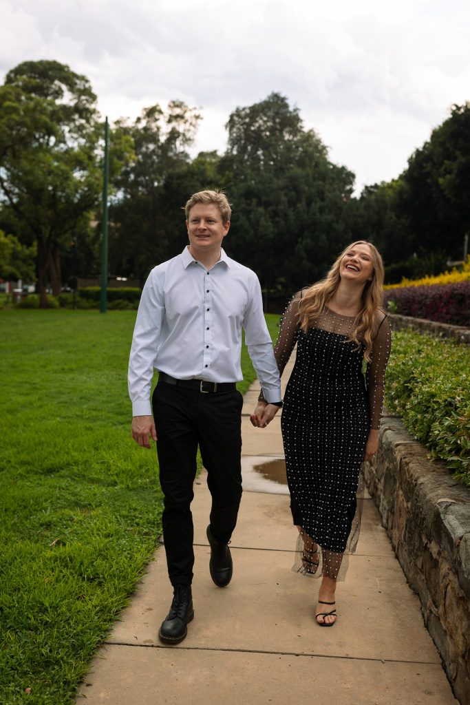 couple walking holding hands in Newcastle on their engagement session