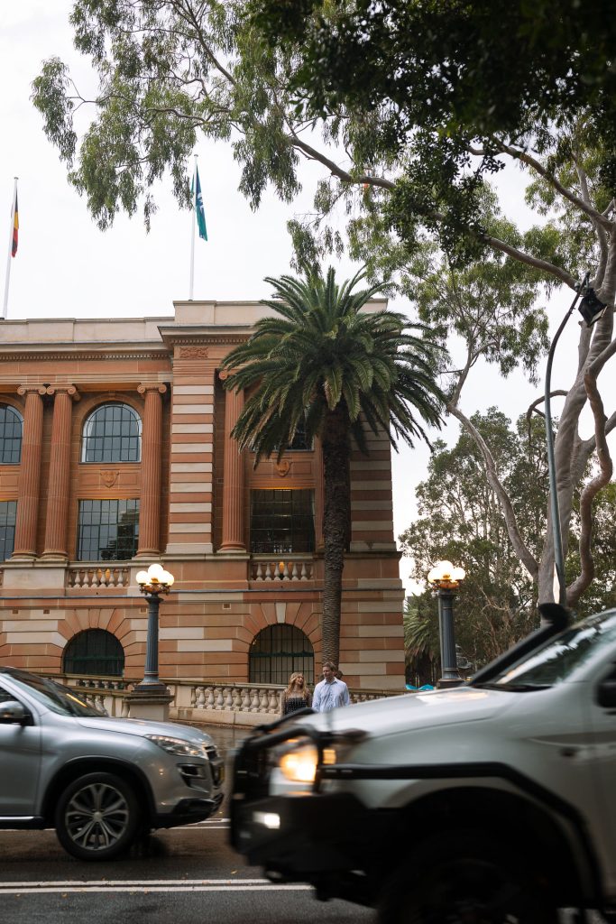couple holding hands in the rain in Newcastle on their engagement session