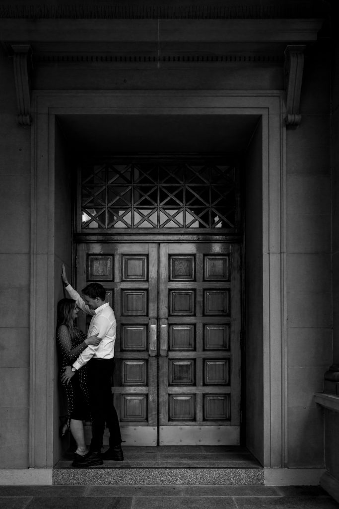 couple kissing at custom house in Newcastle on their engagement session
