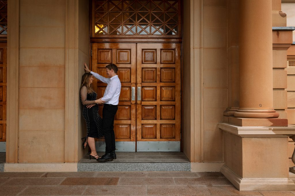 couple kissing at custom house in Newcastle on their engagement session