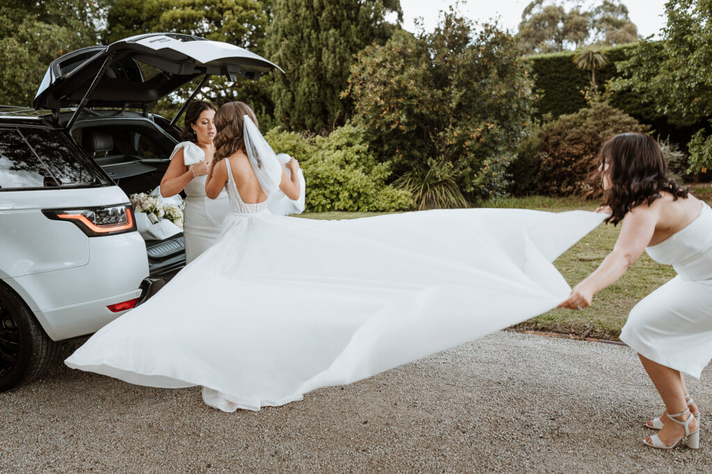 Bride and her dress getting out of the car