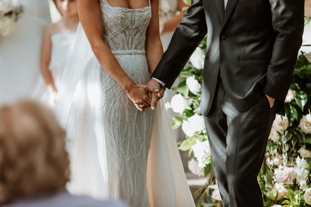bride and groom holding hands