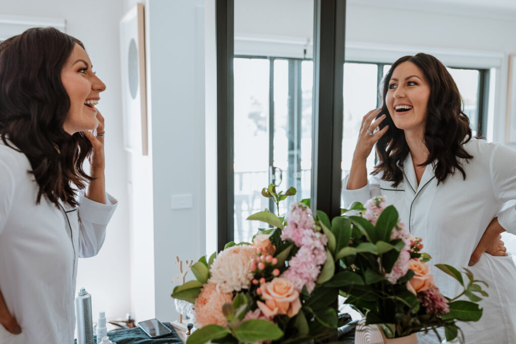 Bridesmaid looking in the mirror getting ready