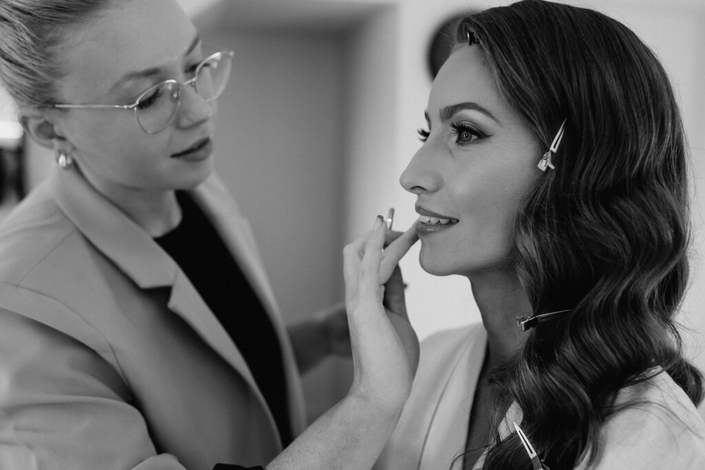 Lipstick being applied to the bride