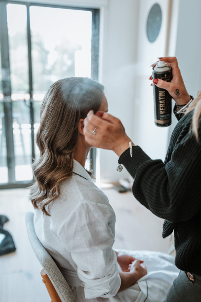 Bride having her hair styled