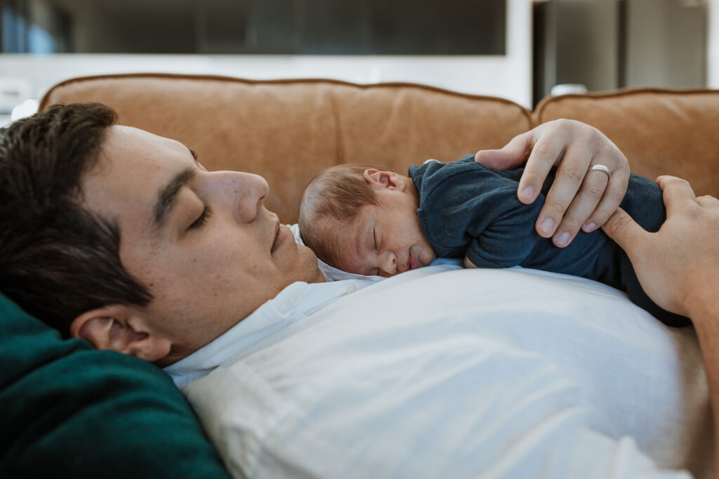 baby lying on dads chest