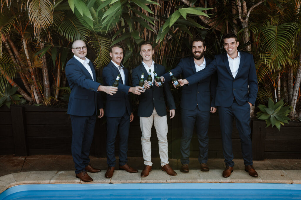 groomsmen outside drinking and celebrating whilst getting ready. Pre Ceremony photos.