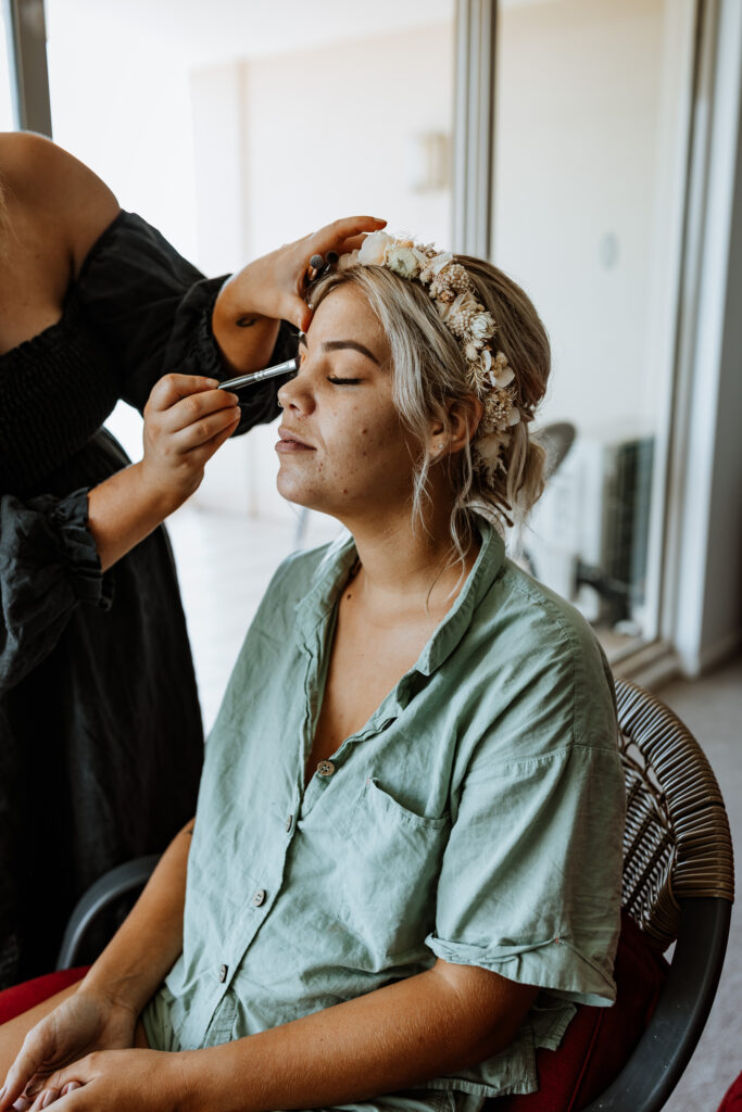 Bride getting ready and having her make up applied