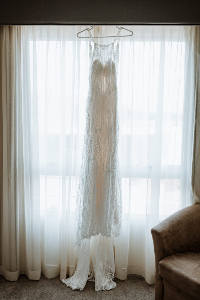 the bride's dress hanging in the window at the house in Port Macquarie