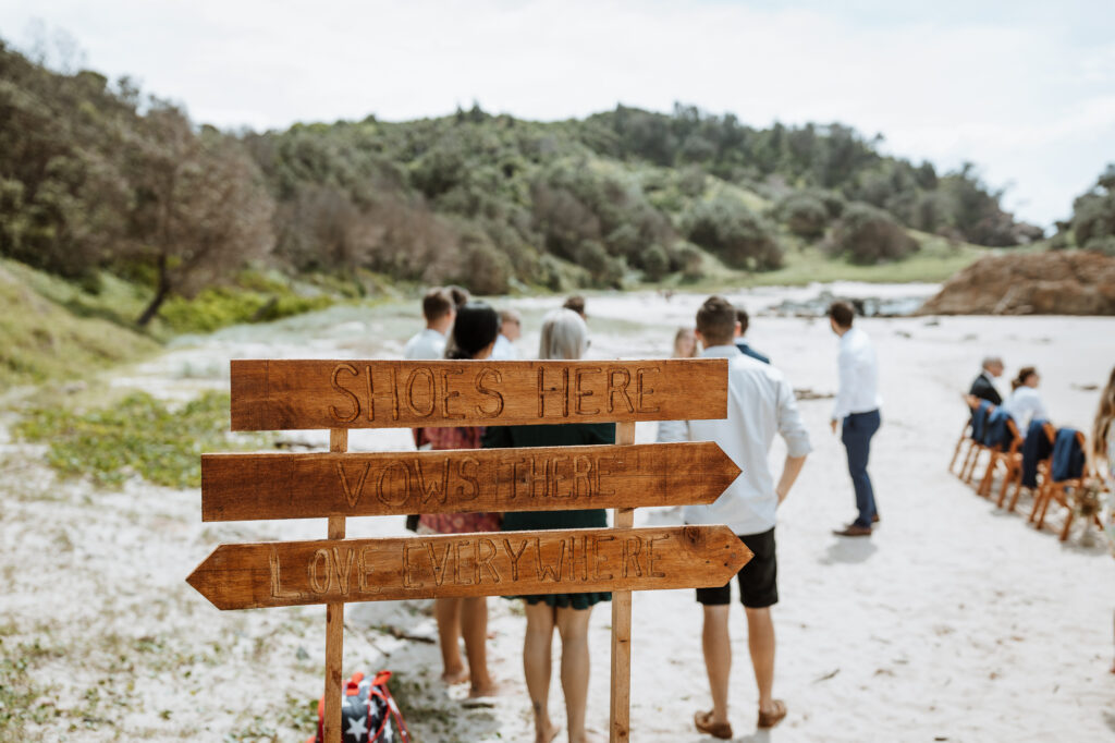 Wooden welcome sign at the wedding in Port Macquarie down on the beach