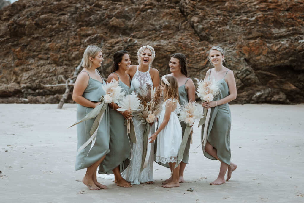 husband and wife photo shoot on the beach in Port Macquarie with the bridal party