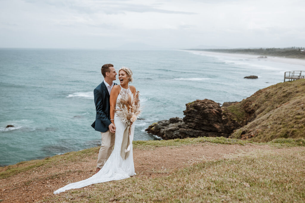husband and wife photo shoot on the beach in Port Macquarie by the lighthouse