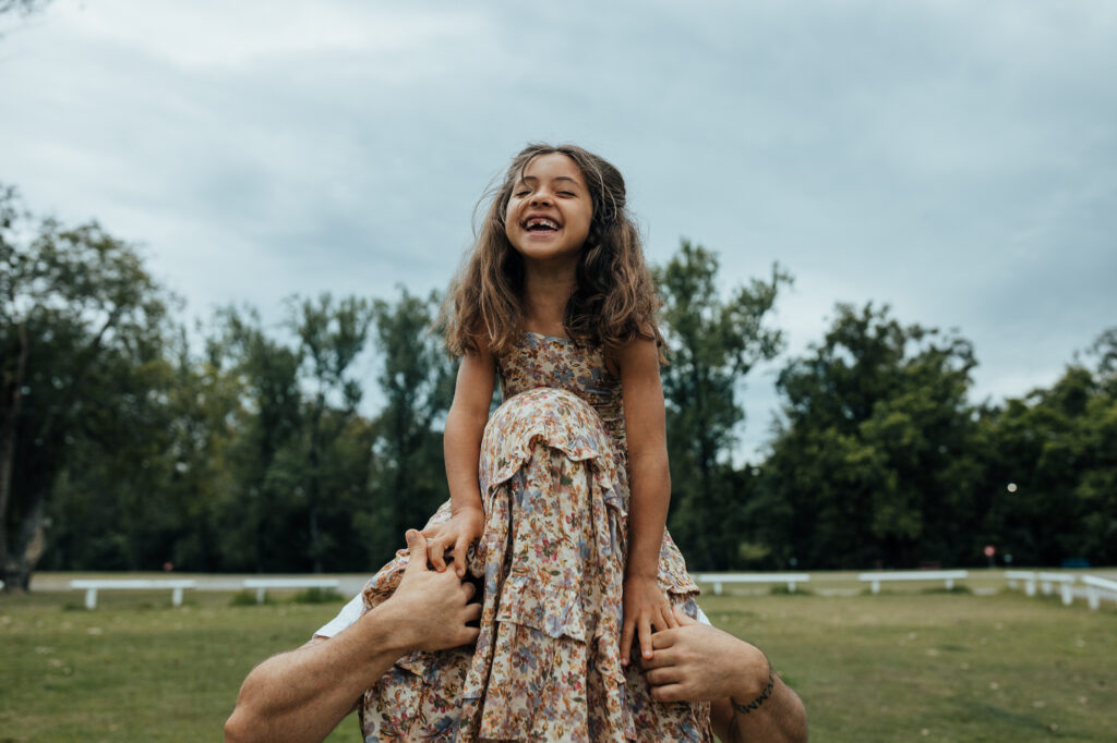 daughter on dad's shoulders