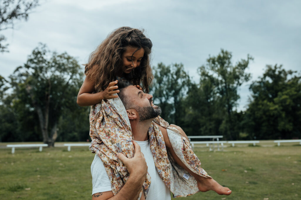 daughter on dad's shoulders