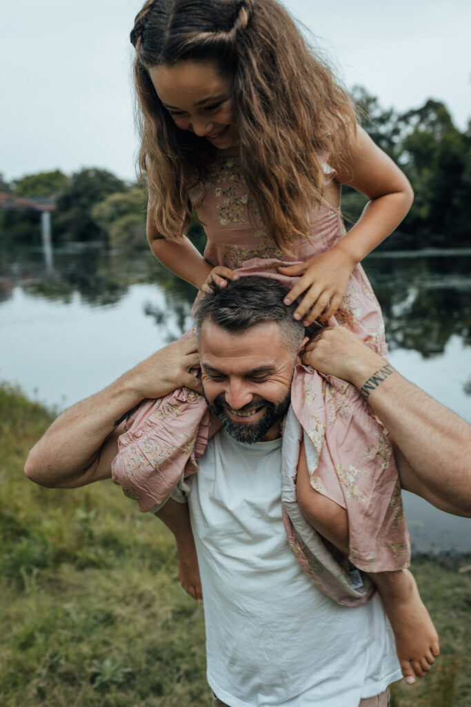 daughter on dad's shoulders