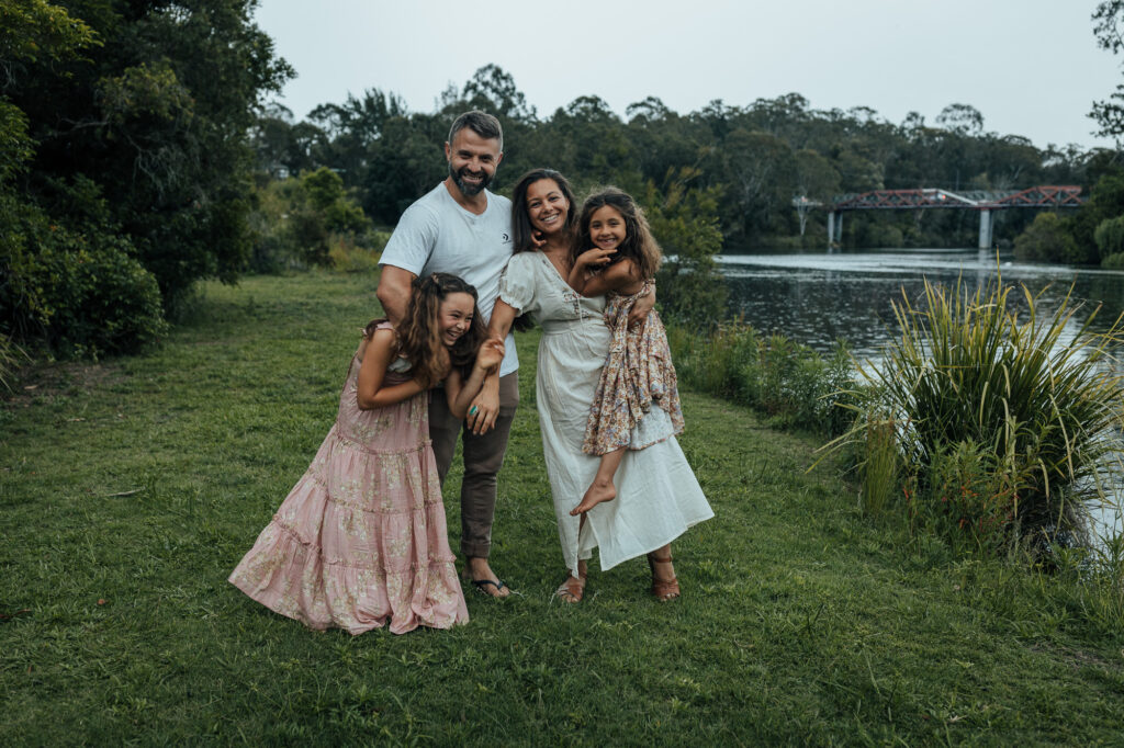 family photo sending up down by the water