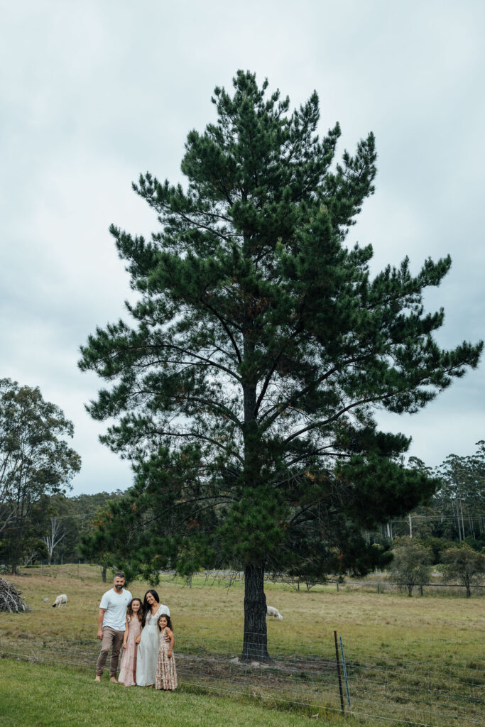 family stood under a large pine tree