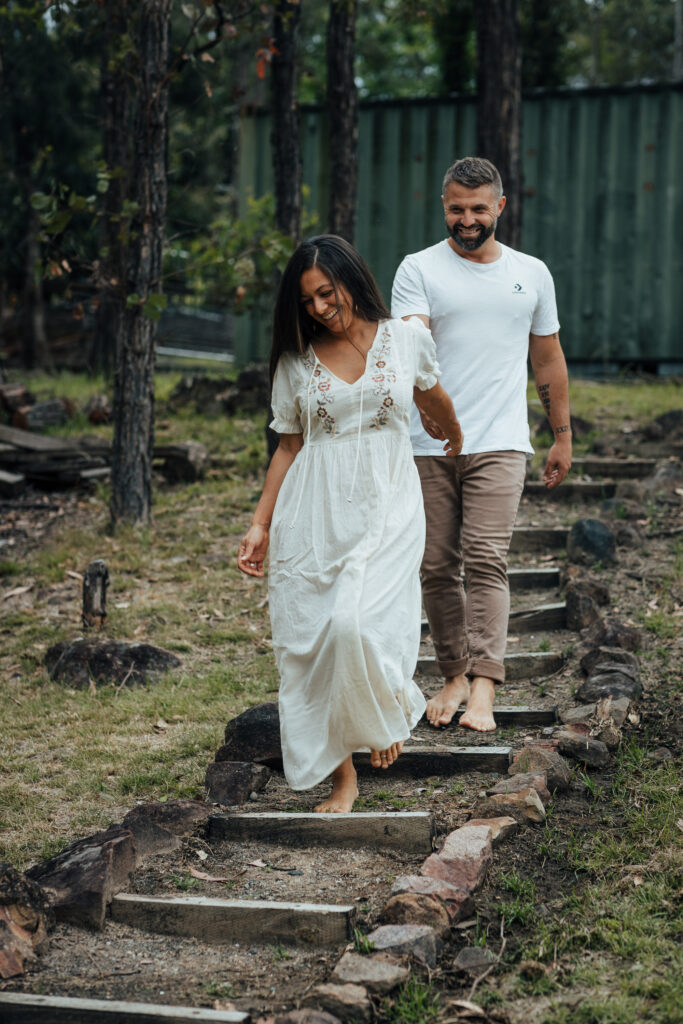 wife walking husband down the stairs