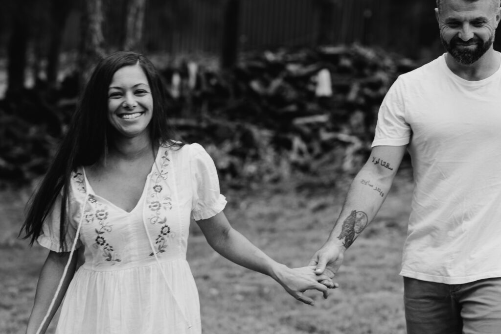 husband and wife holding hands walking towards the camera