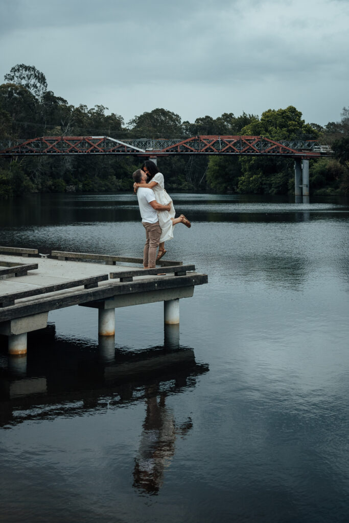 husband and wife having their photo taken on a jetty